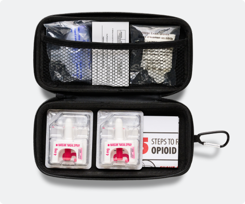 Kit containing NARCAN® Nasal Spray open showing contents